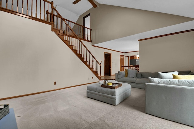 carpeted living room featuring ceiling fan, stairway, high vaulted ceiling, baseboards, and beamed ceiling