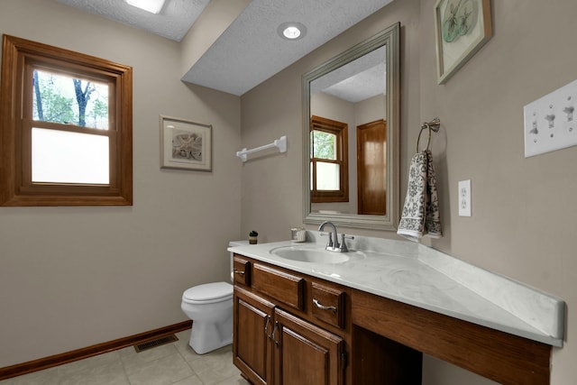 bathroom with toilet, tile patterned floors, visible vents, and a healthy amount of sunlight