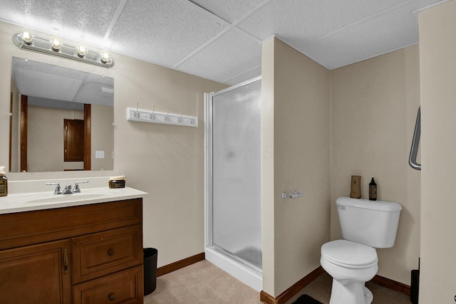 bathroom featuring vanity, baseboards, toilet, and a shower stall