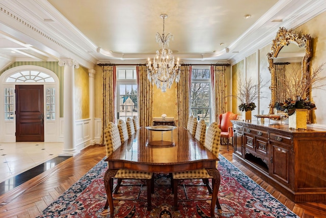 dining space featuring an inviting chandelier, decorative columns, crown molding, and a wealth of natural light