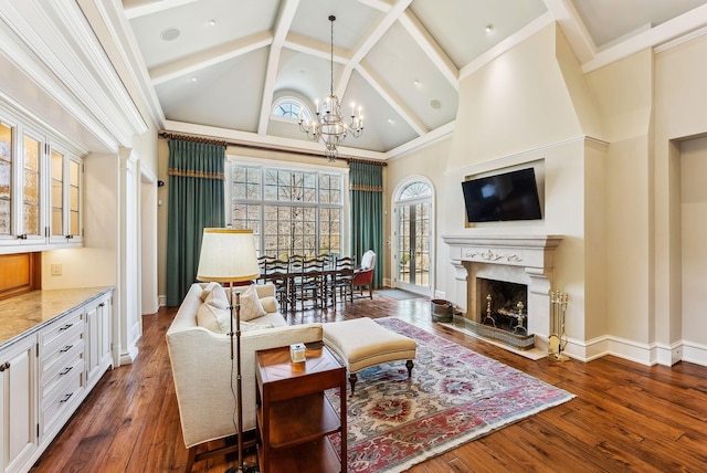 living room with an inviting chandelier, wood-type flooring, a premium fireplace, and high vaulted ceiling