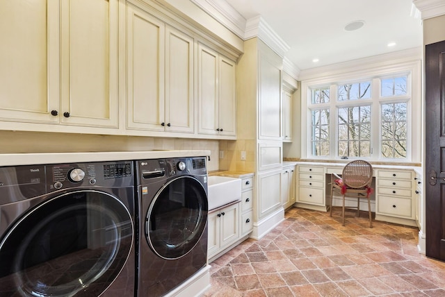 washroom with separate washer and dryer, ornamental molding, stone finish floor, and cabinet space