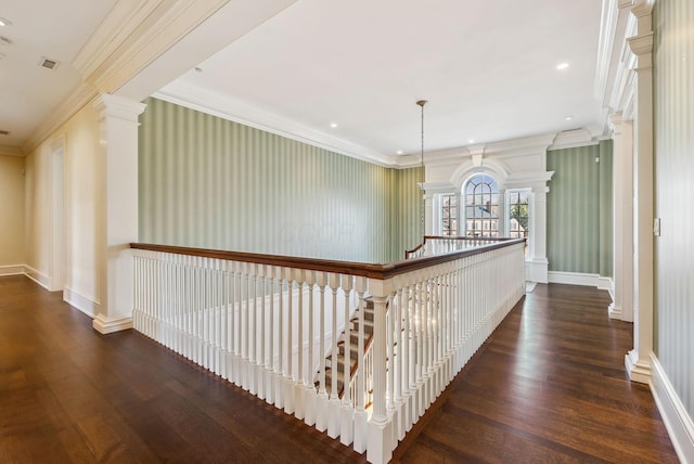corridor with crown molding, baseboards, and wood finished floors