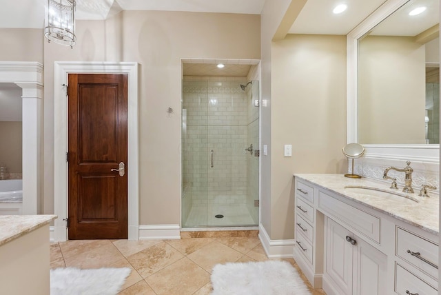 bathroom featuring vanity, baseboards, tile patterned floors, and a shower stall