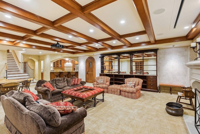 living area with arched walkways, stairway, carpet, and coffered ceiling