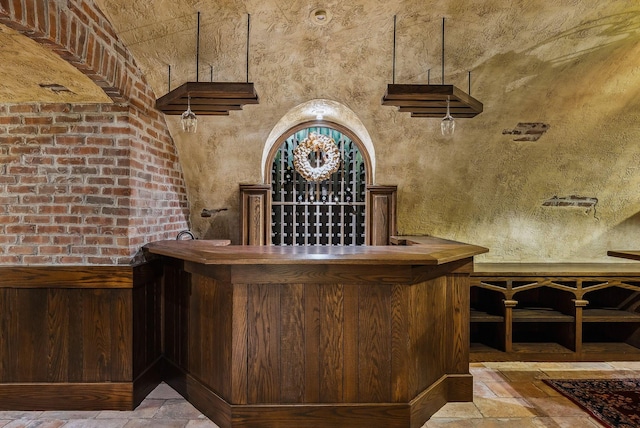 wine area with a bar and stone tile flooring