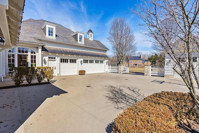 view of property exterior with concrete driveway