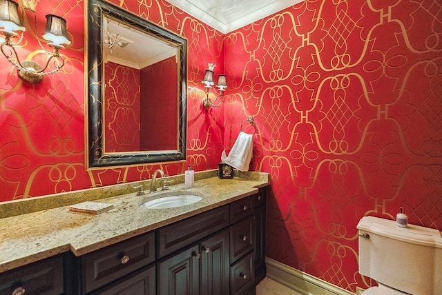 bathroom featuring vanity and wallpapered walls