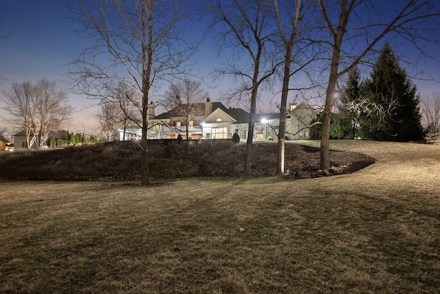 view of yard at dusk