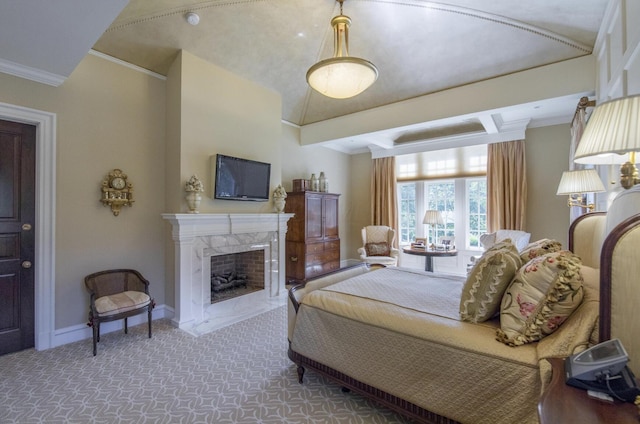bedroom with a high end fireplace, baseboards, crown molding, and carpet