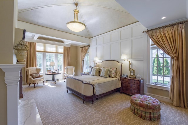 bedroom featuring a decorative wall and light carpet