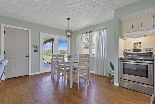 dining room with a textured ceiling, baseboards, a notable chandelier, and dark wood-style floors