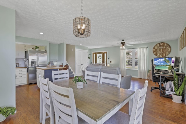 dining area with recessed lighting, a textured ceiling, ceiling fan with notable chandelier, and wood finished floors