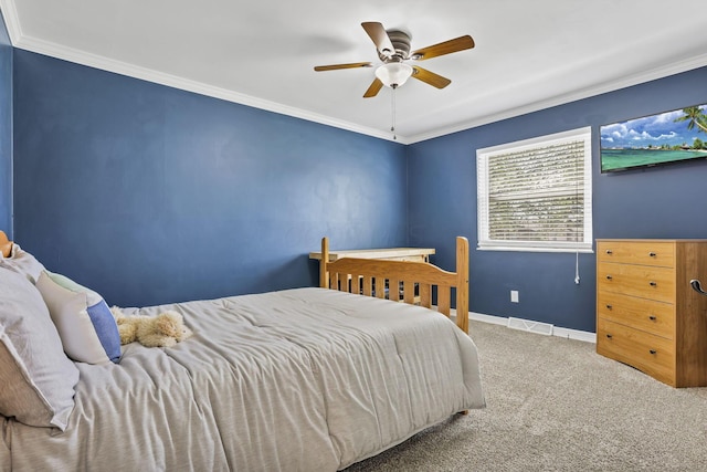 carpeted bedroom with crown molding, baseboards, ceiling fan, and visible vents