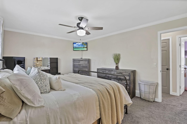 carpeted bedroom featuring crown molding, a ceiling fan, and baseboards