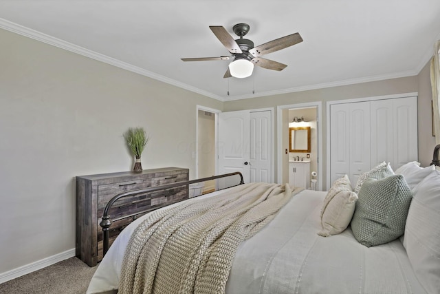 bedroom featuring baseboards, carpet floors, two closets, connected bathroom, and ornamental molding