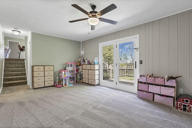 playroom with ceiling fan and carpet