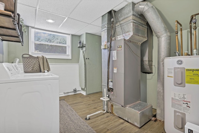 utility room featuring washer and dryer, heating unit, and water heater