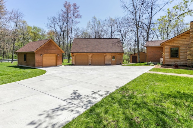 view of home's exterior featuring an outdoor structure, a lawn, roof with shingles, and a detached garage