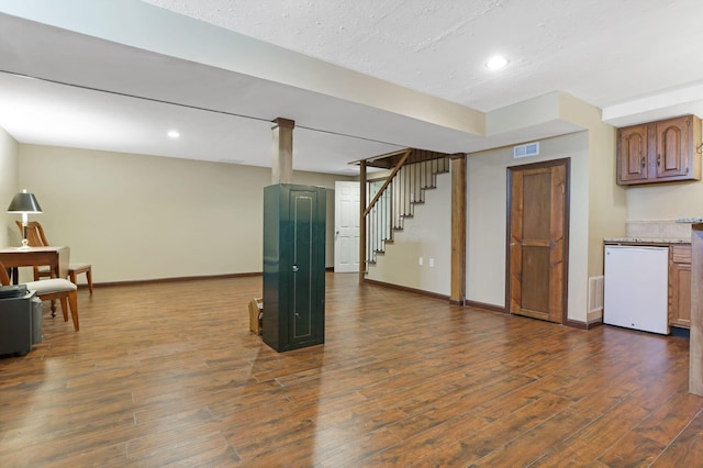 interior space featuring visible vents, baseboards, dark wood-style floors, stairway, and recessed lighting