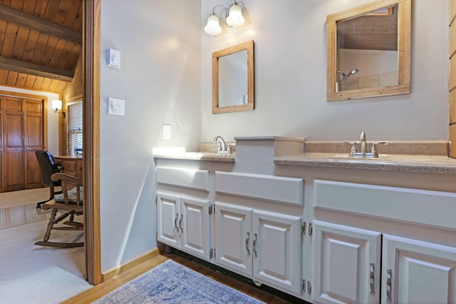 bathroom with double vanity, wood finished floors, a sink, wooden ceiling, and beamed ceiling