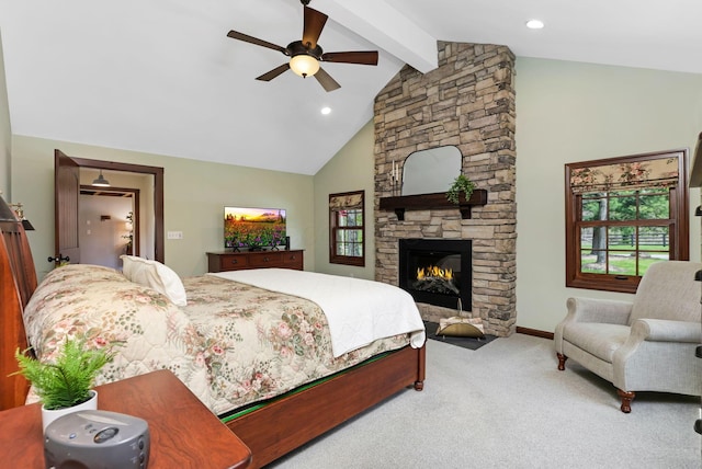 bedroom featuring vaulted ceiling with beams, carpet flooring, a fireplace, and multiple windows