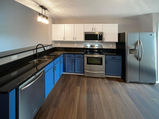 kitchen featuring a sink, appliances with stainless steel finishes, white cabinets, and a textured ceiling