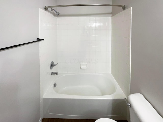 bathroom featuring toilet and tub / shower combination