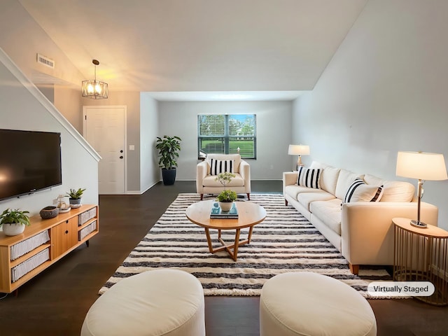 living room with visible vents, dark wood-style flooring, baseboards, a chandelier, and vaulted ceiling