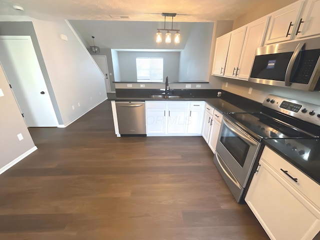 6330 Pompano St, Canal Winchester, OH 43110 - kitchen with stainless steel appliances, a sink, dark countertops, and white cabinetry