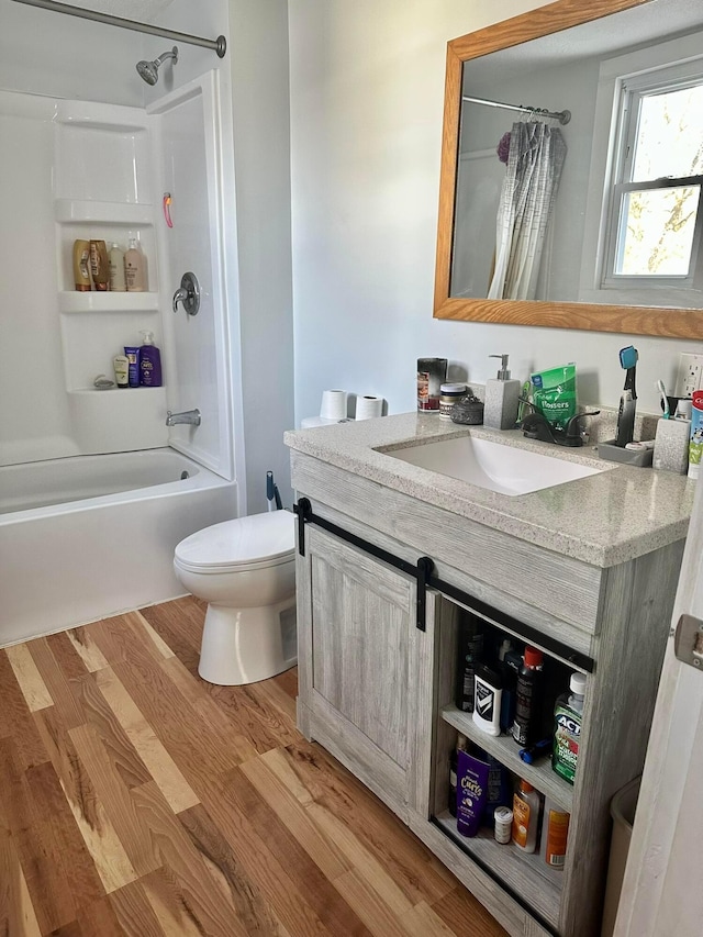 full bath featuring wood finished floors, vanity, toilet, and shower / tub combo with curtain