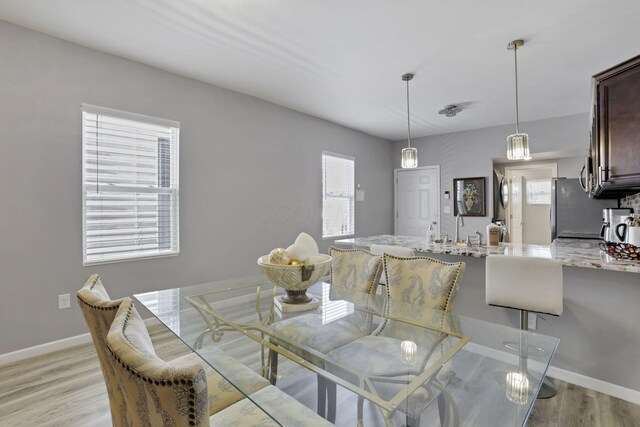 360 Hosack St, Columbus, OH 43207 - dining space featuring light wood-style floors, baseboards, and plenty of natural light