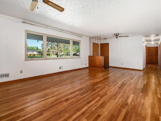 unfurnished living room with visible vents, a ceiling fan, a textured ceiling, and wood finished floors