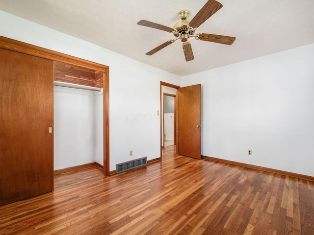 unfurnished bedroom featuring a closet, baseboards, visible vents, and light wood-type flooring