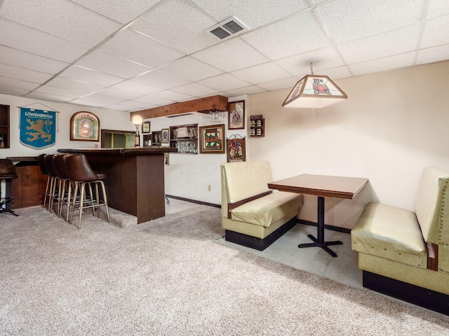 bar with carpet floors, visible vents, a dry bar, and a drop ceiling