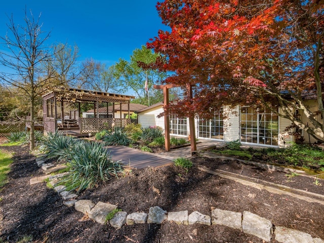 exterior space featuring a deck, fence, and a pergola