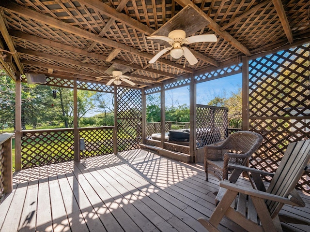 wooden deck featuring ceiling fan