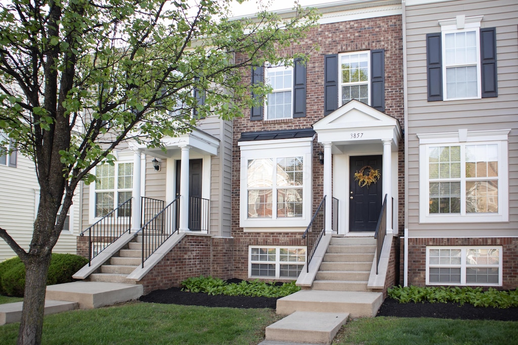 townhome / multi-family property with brick siding