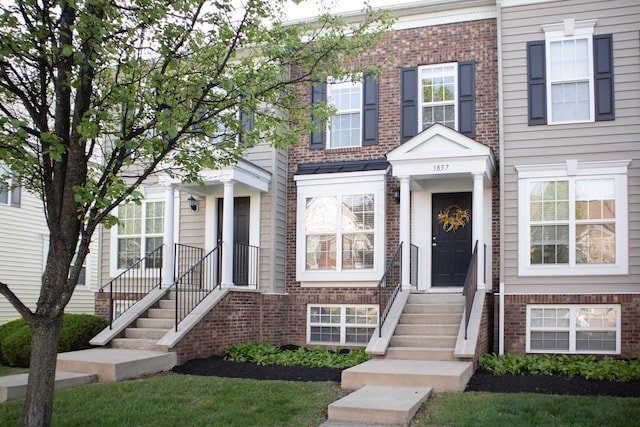 townhome / multi-family property with brick siding