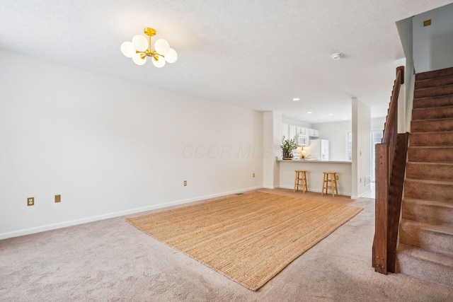 3857 Dowitcher Ln, Columbus, OH 43230 - unfurnished living room featuring stairs, light colored carpet, a chandelier, baseboards, and recessed lighting