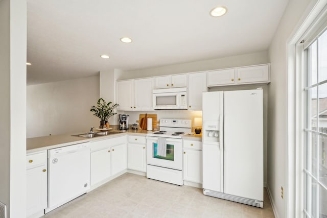 3857 Dowitcher Ln, Columbus, OH 43230 - kitchen with white appliances, a sink, white cabinets, light countertops, and recessed lighting