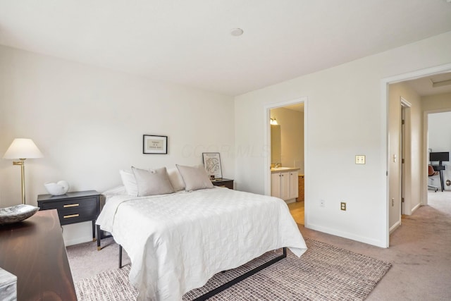 3857 Dowitcher Ln, Columbus, OH 43230 - bedroom featuring light colored carpet, baseboards, and ensuite bath