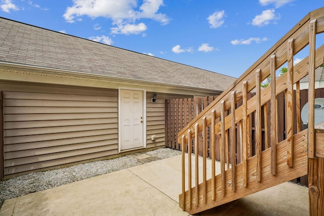 3857 Dowitcher Ln, Columbus, OH 43230 - entrance to property featuring a shingled roof, a patio area, and fence