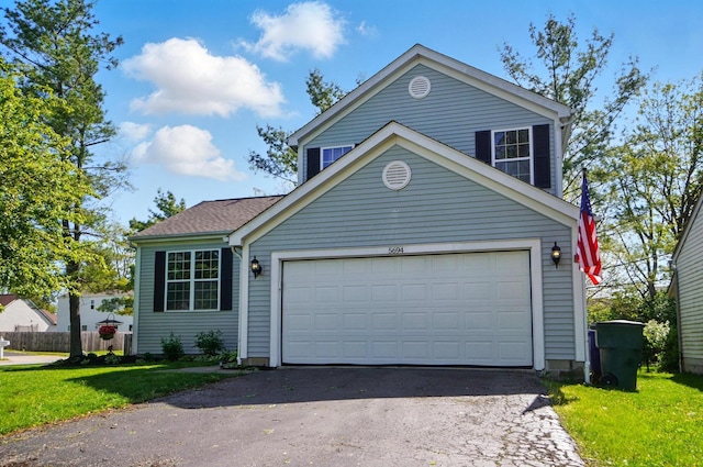 5694 Danmar Dr, Canal Winchester, OH 43110 - traditional home featuring asphalt driveway, a front lawn, and a garage
