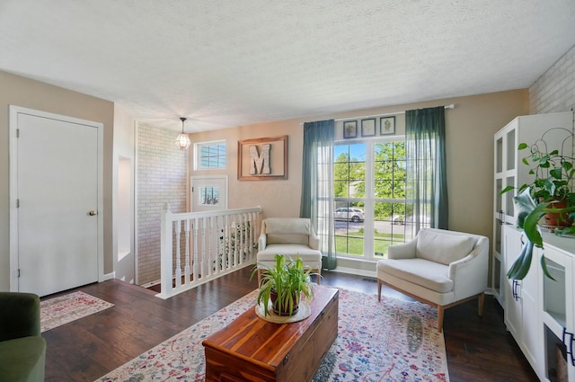5694 Danmar Dr, Canal Winchester, OH 43110 - living room featuring healthy amount of natural light, wood finished floors, and a textured ceiling
