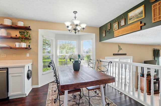 5694 Danmar Dr, Canal Winchester, OH 43110 - dining room with dark wood-style flooring, a chandelier, a textured ceiling, and baseboards