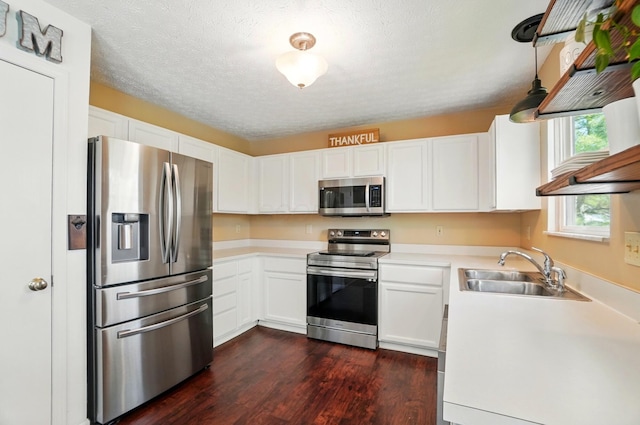 5694 Danmar Dr, Canal Winchester, OH 43110 - kitchen with appliances with stainless steel finishes, a sink, dark wood-style floors, white cabinetry, and a textured ceiling