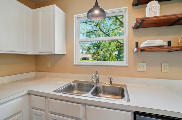5694 Danmar Dr, Canal Winchester, OH 43110 - kitchen with a sink, white cabinetry, light countertops, and hanging light fixtures