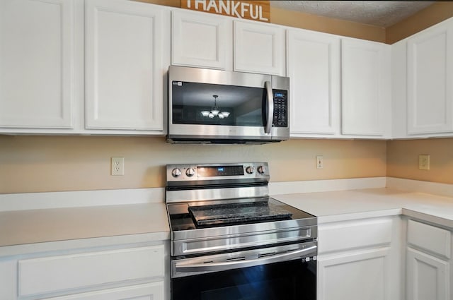 5694 Danmar Dr, Canal Winchester, OH 43110 - kitchen with stainless steel appliances, light countertops, and white cabinetry
