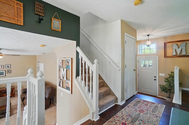 5694 Danmar Dr, Canal Winchester, OH 43110 - entryway featuring a textured ceiling, wood finished floors, baseboards, ceiling fan, and stairway